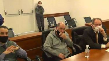 El imputado Lucini junto a su abogado, el día de la audiencia de formulación de cargos en julio pasado.