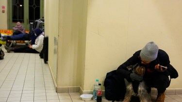 Una mujer ucraniana se sienta con su perro en una estación de tren que se convirtió en un centro de alojamiento en Przemysl, Polonia(AP Photo/Petr David Josek)