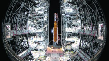 NASA's Space Launch System (SLS) rocket with the Orion spacecraft aboard is seen atop the mobile launcher as it rolls out to Launch Pad 39B, Friday, Nov. 4, 2022, at NASA's Kennedy Space Center in Florida. (Joel Kowsky/NASA via AP)