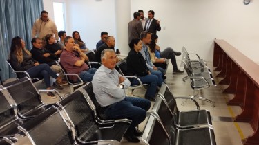Di Luca, junto con los otros imputados, en la sala de audiencias.