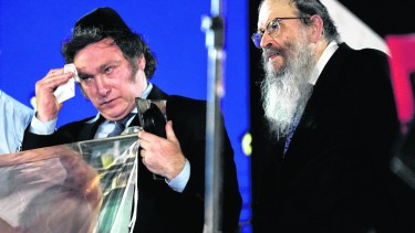 Argentina's new President Javier Milei attends a Hanukkah celebration marking the sixth night of the Jewish Festival of Lights, at a park in Buenos Aires, Argentina, Tuesday, Dec. 12, 2023. (AP Photo/Rodrigo Abd)
