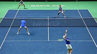 Matteo Berrettini (BOTTOM R), playing with Jannik Sinner of Team Italy, serves the ball against Maximo Gonzalez (TOP R) and Andres Molteni of Team Argentina during their quarter-final doubles match between Italy and Argentina at the Davis Cup Finals at the Palacio de Deportes Jose Maria Martin Carpena arena in Malaga, southern Spain, on November 21, 2024. (Photo by JORGE GUERRERO / AFP)